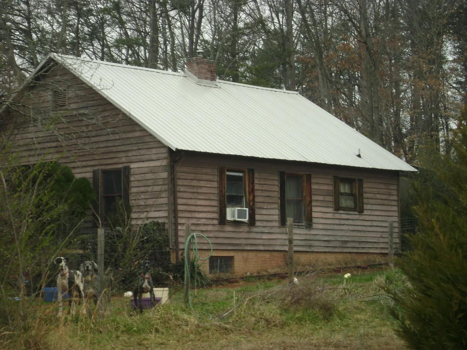 White metal roof on an old wood sided farmhouse, from a Metal Roof Installation job in Algodones